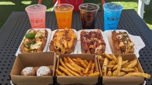 Four cocktails, four gourmet hot dogs, and three different sides including fries